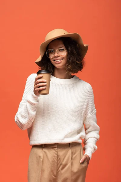 Lachende Vrouw Hoed Glazen Vasthouden Van Koffie Gaan Geïsoleerd Oranje — Stockfoto