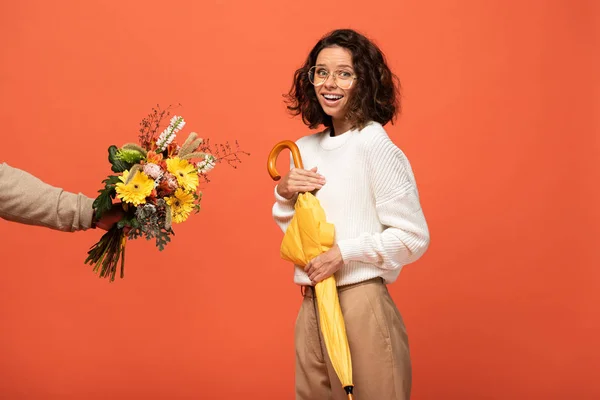 Boyfriend Gifting Surprised Woman Umbrella Bouquet Flowers Isolated Orange — Stock Photo, Image