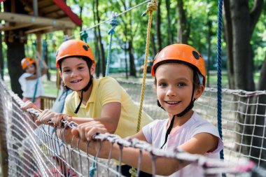 selective focus of happy kids in adventure park  clipart