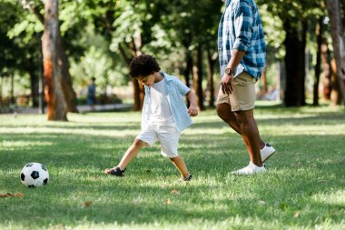 sevimli oğlu ile futbol oynayan Afrikalı-Amerikalı baba kırpılmış görünümü 