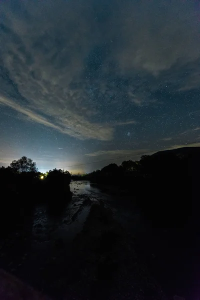 evening sky with clouds in forest at night 