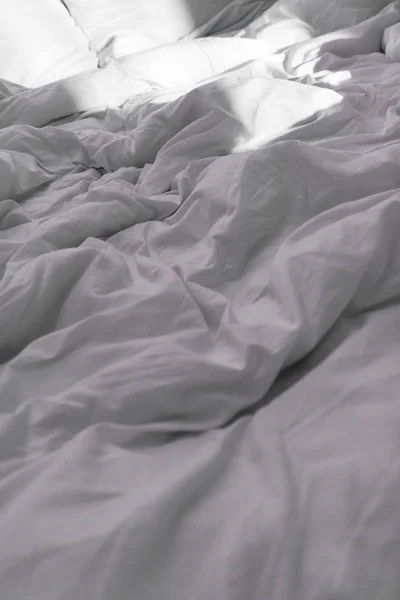 selective focus of bed with white blanket in daytime
