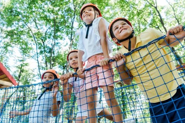 Low Angle View Smiling Kids Orange Helmets Multicultural Boys Adventure — Stock Photo, Image