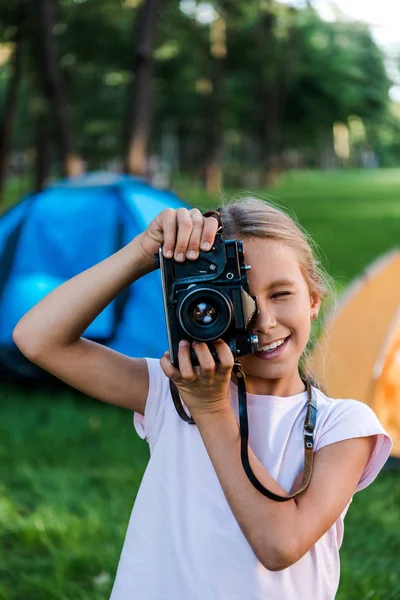 Happy Kid Holding Digital Camera While Taking Photo Camps — Stock Photo, Image