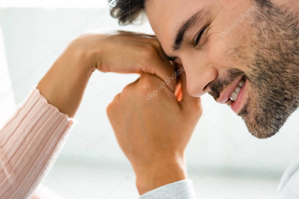 cropped view of man holding hand of african american woman 