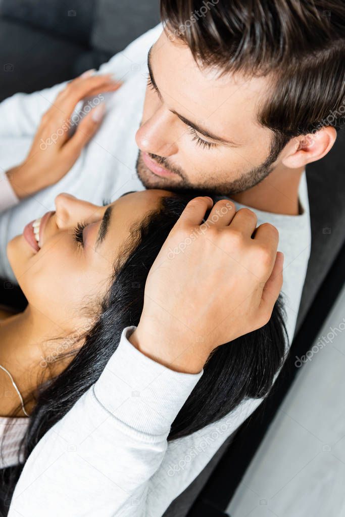 high angle view of african american woman and man hugging 