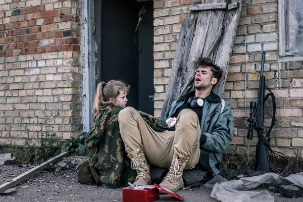 Kid Holding Medical Bandage Man Sitting Ground Post Apocalyptic Concept — Stock Photo, Image