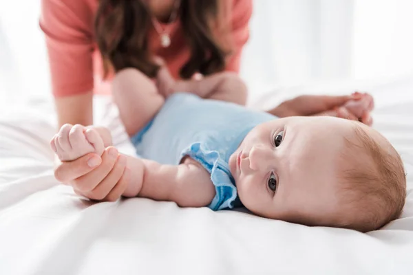 Cropped View Woman Touching Hands Infant Daughter Bed — Stock Photo, Image