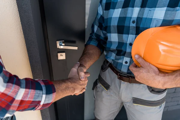 Cropped View Builders Shaking Hands While Standing Door — Stock Photo, Image