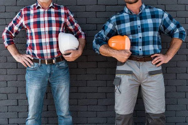 Cropped View Men Standing Hands Hips Holding Helmets — Stock Photo, Image