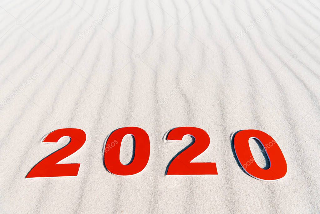 2020 numbers on white sand on beach in Maldives