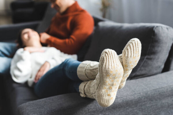 selective focus of girlfriend in wool socks in apartment 