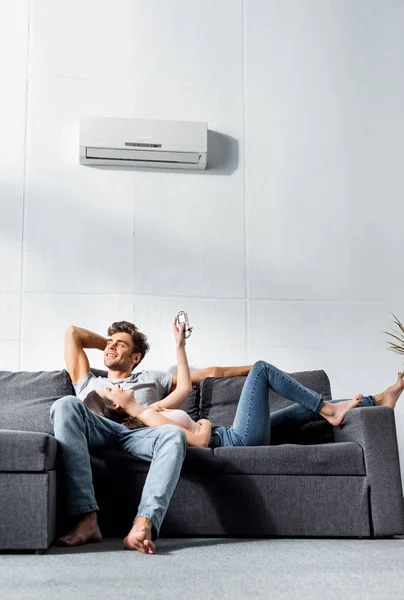 Attractive Girlfriend Switching Air Conditioner Lying Legs Handsome Boyfriend — Stock Photo, Image