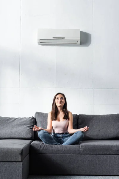 Attractive Smiling Woman Lotus Pose Sitting Sofa — Stock Photo, Image