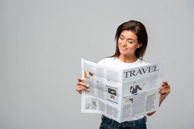 attractive smiling woman reading travel newspaper, isolated on grey clipart