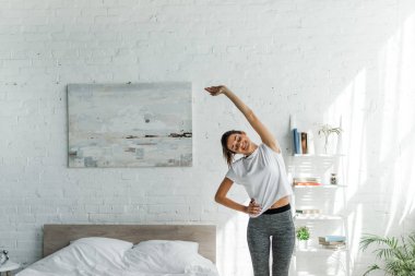 beautiful happiness woman doing morning exercise in bedroom