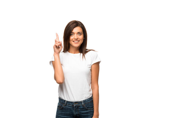 beautiful smiling woman in white t-shirt pointing up, isolated on white