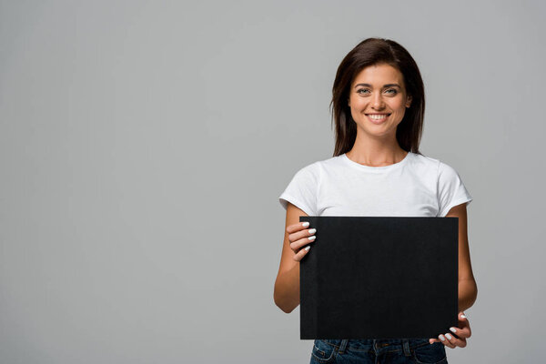 beautiful smiling girl holding empty black, isolated on grey