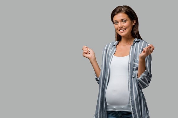 beautiful cheerful pregnant woman posing isolated on grey