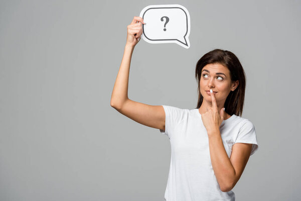 thoughtful woman holding speech bubble with question mark, isolated on grey