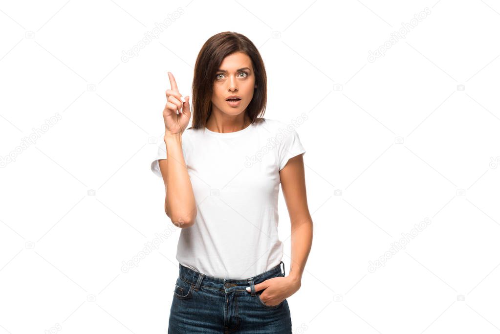 beautiful shocked woman in white t-shirt pointing up, isolated on white