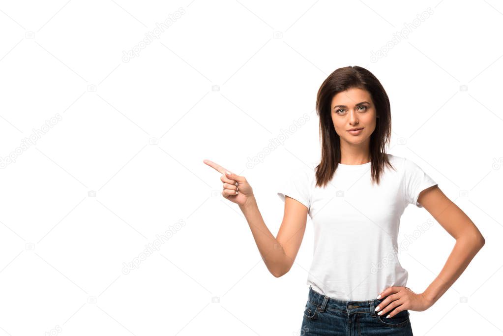 beautiful woman in white t-shirt pointing at something, isolated on white