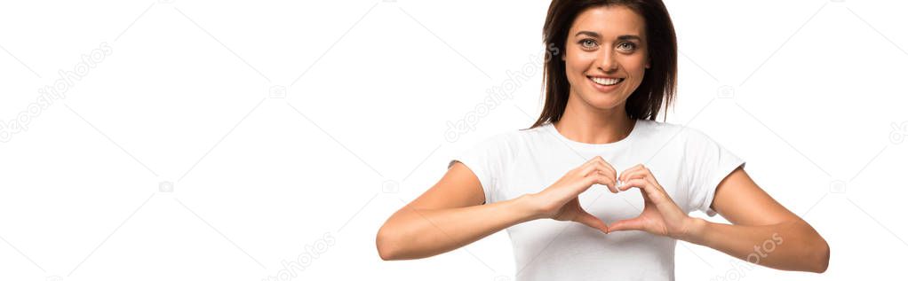 cheerful woman in white t-shirt showing heart sign, isolated on white