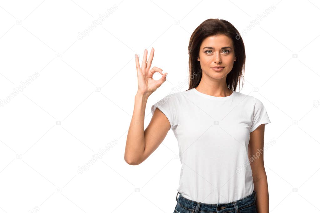 attractive girl in white t-shirt showing ok sign, isolated on white