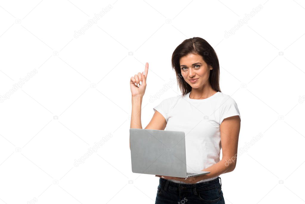smiling woman pointing up and having idea while using laptop, isolated on white