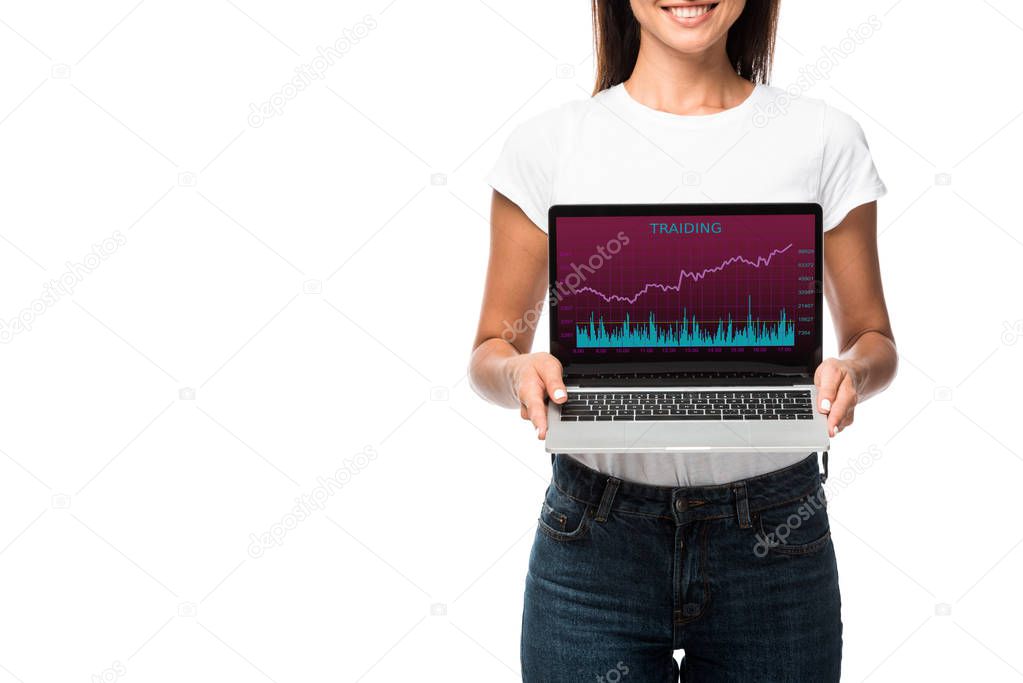 beautiful smiling woman showing laptop with trading app, isolated on white