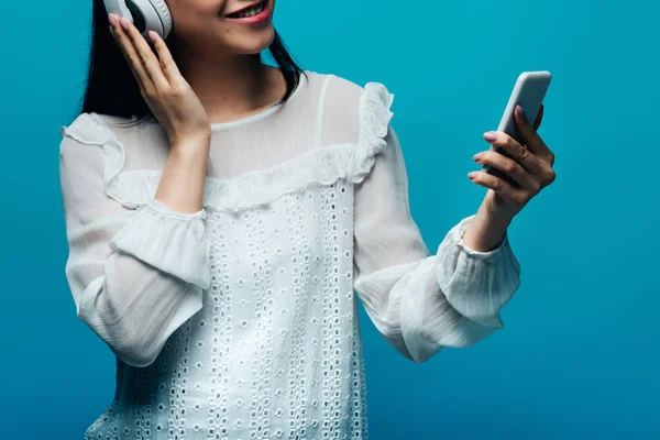 Cropped View Smiling Asian Woman Headphones Using Smartphone Blue Background — Stock Photo, Image