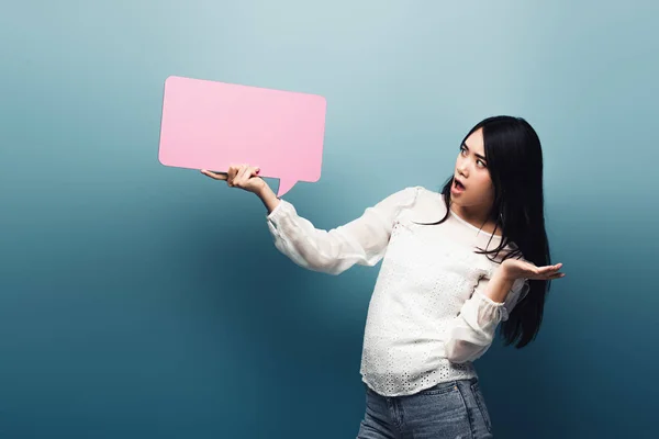 Shocked Brunette Asian Woman Holding Pink Speech Bubble Blue Background — Stock Photo, Image