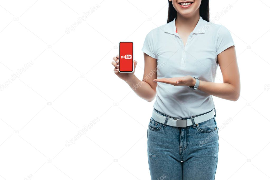 KYIV, UKRAINE - JULY 15, 2019: cropped view of happy brunette asian woman presenting smartphone with youtube app isolated on white