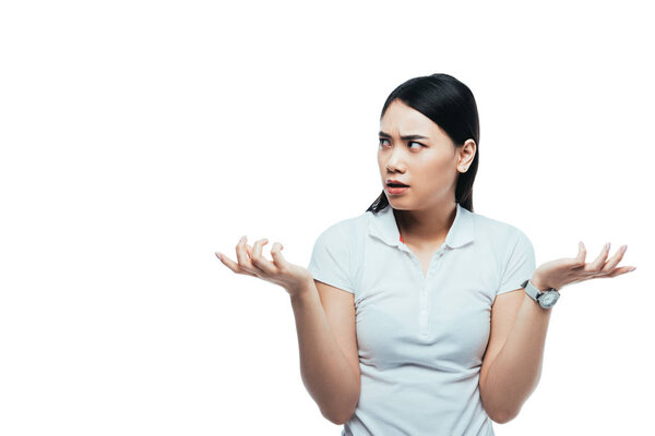 confused attractive asian girl showing dubium gesture isolated on white