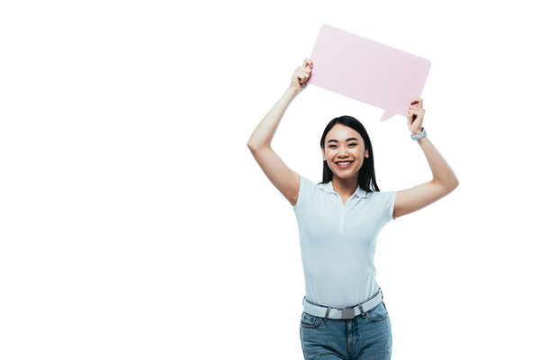 happy attractive asian girl holding pink blank speech bubble isolated on white