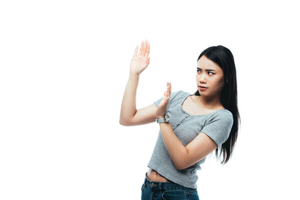displeased asian girl showing no gesture isolated on white