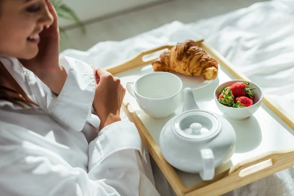 朝にベッドで朝食を取った白いシャツの女性の — ストック写真