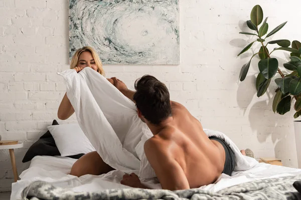 Smiling Young Couple Having Fun Pillow Battle Bed Morning — Stock Photo, Image