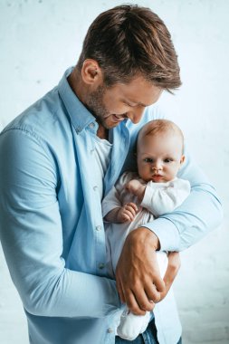 Mutlu baba gülümserken kucağında tatlı bir kız çocuğu