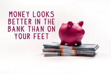 pink piggy bank on stack of russian rubles on white background with money looks better in the bank than on your feet illustration clipart