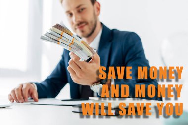 selective focus of businessman holding money in office with save the money and money will save you illustration clipart