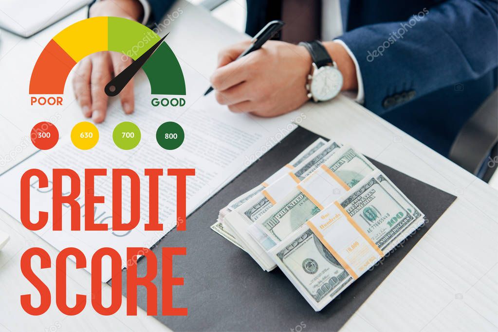 cropped view of businessman signing contract near money in office with credit score illustration