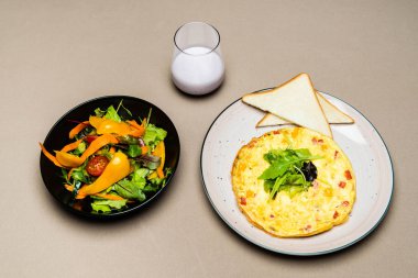  salad, omelet, toasts and yogurt in glass on table  clipart
