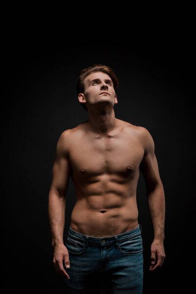 handsome sensual man posing isolated on black