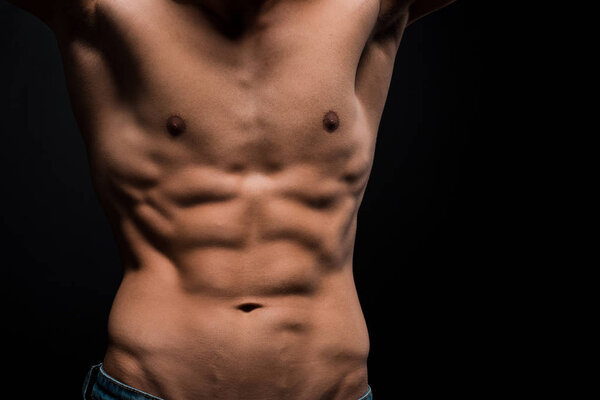 cropped view of shirtless male torso isolated on black