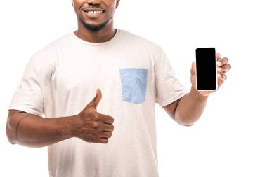 Siyah ekranlı akıllı telefonu tutan ve beyaz ekranda izole edilmiş parmağını gösteren gülümseyen Afrikalı Amerikalı adamın kısmi görüntüsü