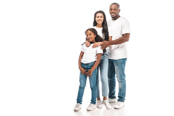 happy african american husband, wife and daughter looking at camera while standing on white background