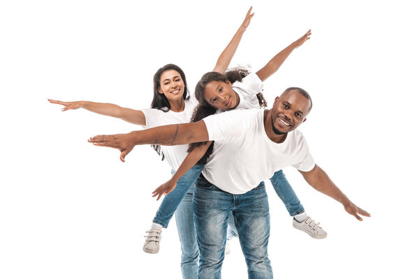 cheerful african american family imitating flying with outstretched hands on white background