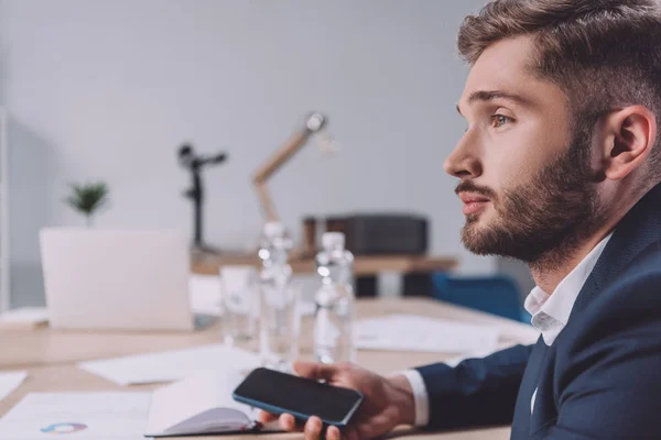 Pensive Businessman Holding Smartphone While Sitting Meeting Room — ストック写真
