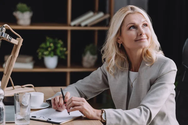 Attractive Mature Businesswoman Looking Away While Sitting Desk Meeting Room — Stock Photo, Image